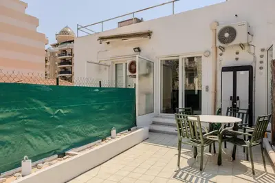 a patio with a table and chairs on a balcony at Nice, Studio Grande Terrasse à 2 pas de la promenade in Nice