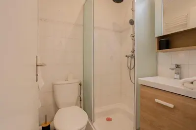 a bathroom with a shower with a toilet and a sink at Nice, Studio Grande Terrasse à 2 pas de la promenade in Nice