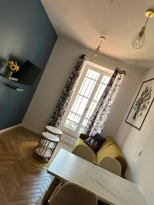 a living room with a couch and a window at MOON 21 in Nice