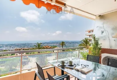 a glass table and chairs on a balcony with a view at Absea Nice Belles Terres 4 in Nice