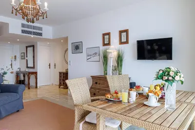 a living room with a table with fruit on it at MY CASA - VILLEFRANCHE RESTANQUES - Panoramic sea view 2 bedrooms Swimming pool in Villefranche-sur-Mer