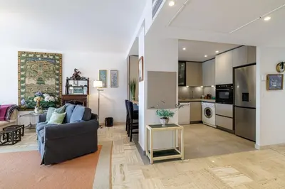 a living room with a couch and a kitchen at MY CASA - VILLEFRANCHE RESTANQUES - Panoramic sea view 2 bedrooms Swimming pool in Villefranche-sur-Mer