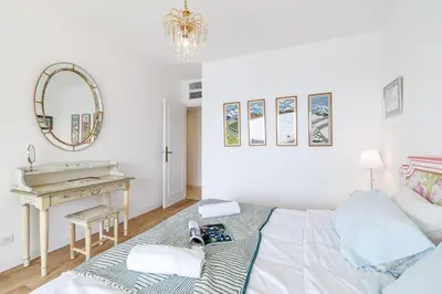 a bedroom with a bed and a desk and a mirror at MY CASA - VILLEFRANCHE RESTANQUES - Panoramic sea view 2 bedrooms Swimming pool in Villefranche-sur-Mer