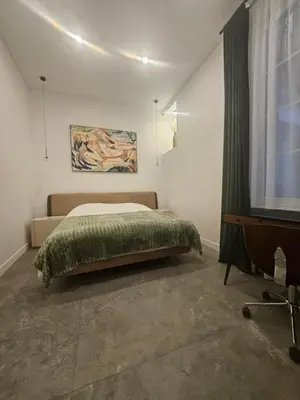 a bedroom with a bed and a painting on the wall at Paganini 3bd Apartment in Nice
