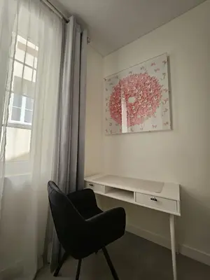 a desk and a chair in a room with a window at Paganini 3bd Apartment in Nice