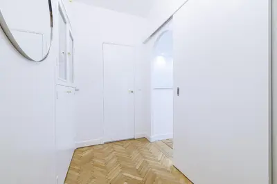 a hallway with white walls and a mirror at Capitol Close To The Beach - Happy Rentals in Nice