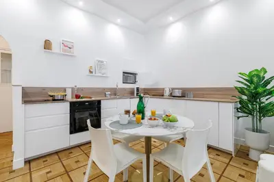 a kitchen with a table and chairs in a kitchen at Capitol Close To The Beach - Happy Rentals in Nice