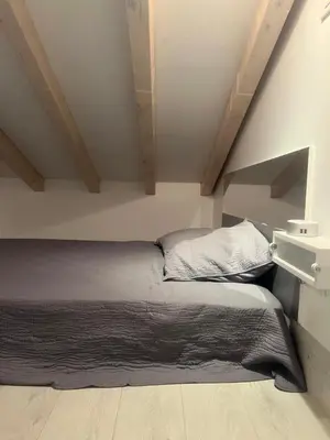 a bedroom with a bed in a attic at Cosy studio piscine eze bord de mer in Èze