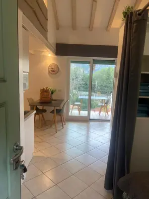 a kitchen and dining room with a table at Cosy studio piscine eze bord de mer in Èze