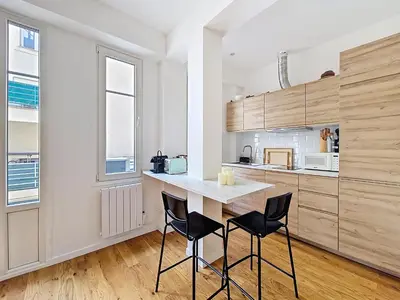 a kitchen with a white counter and two chairs at Nestor&Jeeves - GOLDEN SQUARE - Near Promenade des Anglais in Nice