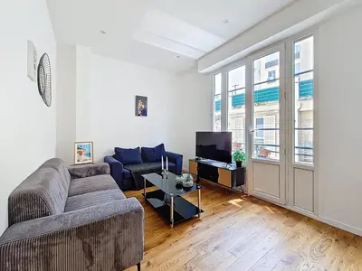 a living room with a couch and a tv at Nestor&Jeeves - GOLDEN SQUARE - Near Promenade des Anglais in Nice