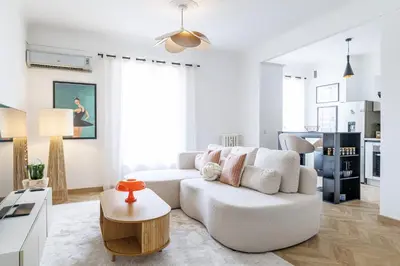 a white living room with a white couch and a table at Wide & Cozy 1 Bdr Downtown in Nice
