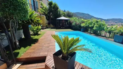 a swimming pool in the backyard of a house at Villa in Nice French Riviera in Nice