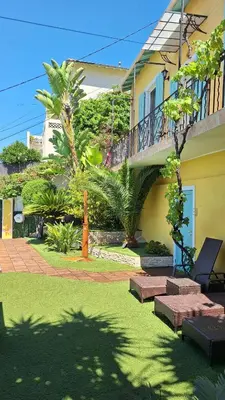 a yard with benches and a house with a balcony at Villa in Nice French Riviera in Nice