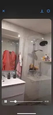 a bathroom with a sink and a shower and a mirror at Endroit calme in Nice