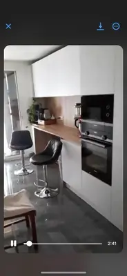 a kitchen with two chairs and a counter and a stove at Endroit calme in Nice