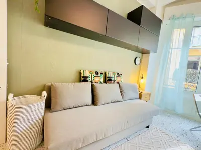 a bedroom with a white bed with pillows on it at Petit Bijou 1 Pers Centrale WiFI in Nice