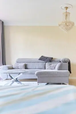 a living room with two couches and a chandelier at Appartement 3 pièces Nice-Ouest in Nice