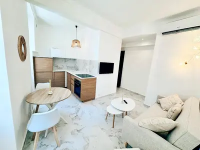 a living room with a couch and a table at Nest In Nice in Nice