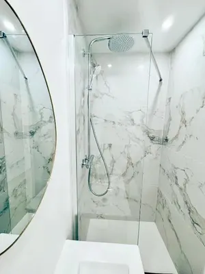 a bathroom with a shower with a mirror at Nest In Nice in Nice