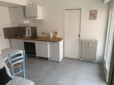 a kitchen with a counter top and a table at studio 30m2 in Nice