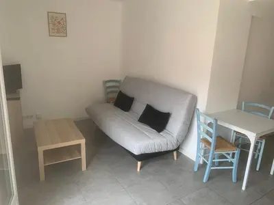 a small living room with a couch and a table at studio 30m2 in Nice