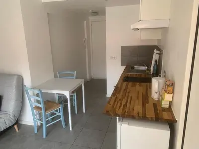 a small kitchen with a table and a table and chairs at studio 30m2 in Nice