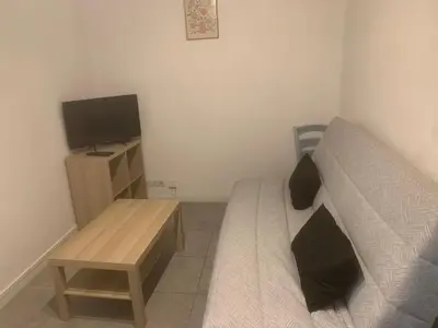 a small bedroom with a bed and a television at studio 30m2 in Nice
