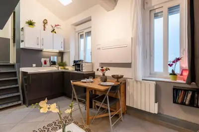 a kitchen with a small table and a kitchen sidx sidx sidx at Cute duplex studio in Nice