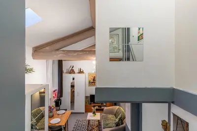 a view of a living room with a table and chairs at Cute duplex studio in Nice