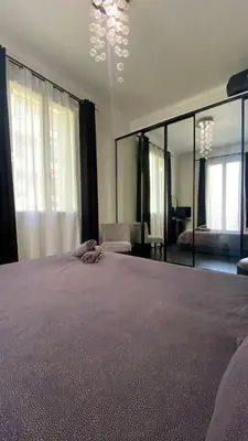 a large bedroom with a large bed and a mirror at République in Nice