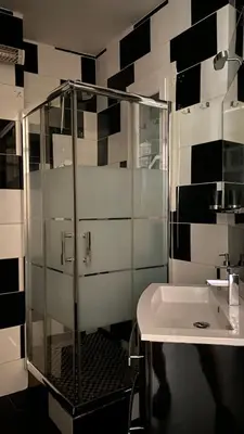 a bathroom with a glass shower and a sink at République in Nice