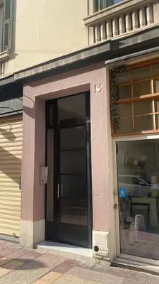 a store front with a door in a building at République in Nice