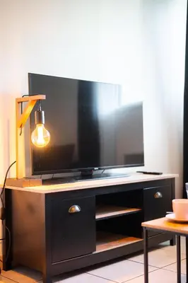 a flat screen tv sitting on top of a entertainment center at Studio Nice , proche mer et aéroport in Nice