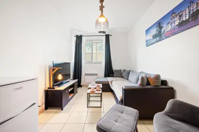 a living room with a couch and a table at Studio Nice , proche mer et aéroport in Nice