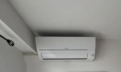a white tv hanging from the ceiling of a room at Appartement-Centre ville -Climatisé-Terrasse-Parking in Cagnes-sur-Mer