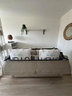 a large bed in a room with white walls at Appartement-Centre ville -Climatisé-Terrasse-Parking in Cagnes-sur-Mer