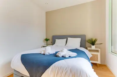 a bedroom with a bed with towels on it at 33 MARINONI AP4438 by Riviera Holiday Homes in Beaulieu-sur-Mer