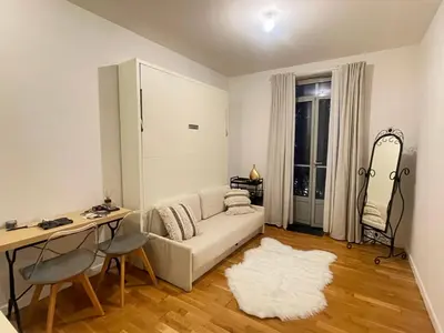 a living room with a white couch and a table at Studio Carabacel in Nice