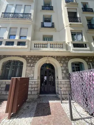 a large white building with a wooden door at Studio Carabacel in Nice