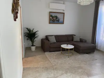 a living room with a brown couch and a table at Katy in Nice