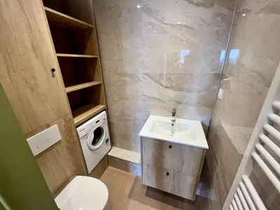 a bathroom with a sink and a washing machine at Nice Signature Halevy Terrasse in Nice