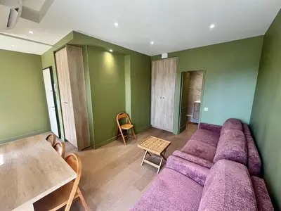 a living room with a purple couch and a table at Nice Signature Halevy Terrasse in Nice