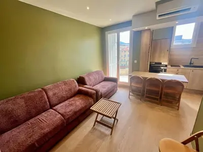 a living room with a couch and a table at Nice Signature Halevy Terrasse in Nice
