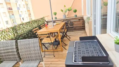 a patio with a table and chairs on a balcony at Superbe appartement 3P neuf - terrasse - barbecue in Nice