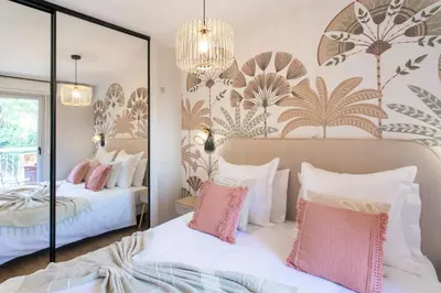 a bedroom with two beds and a mirror at Appartement cosy lumineux avec balcon in Nice