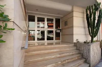 a staircase leading to a building with a cactus at Appartement cosy lumineux avec balcon in Nice