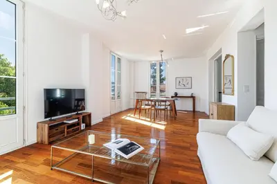 a large kitchen with a wooden table and chairs at Wide 1 Bdr Quiet Area Open View in Nice