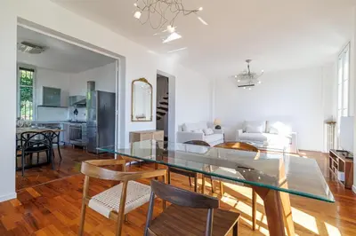 a living room with a white couch and a glass table at Wide 1 Bdr Quiet Area Open View in Nice