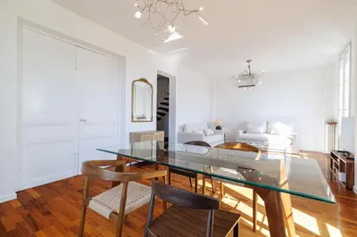 a white living room with a white couch and a glass table at Wide 1 Bdr Quiet Area Open View in Nice